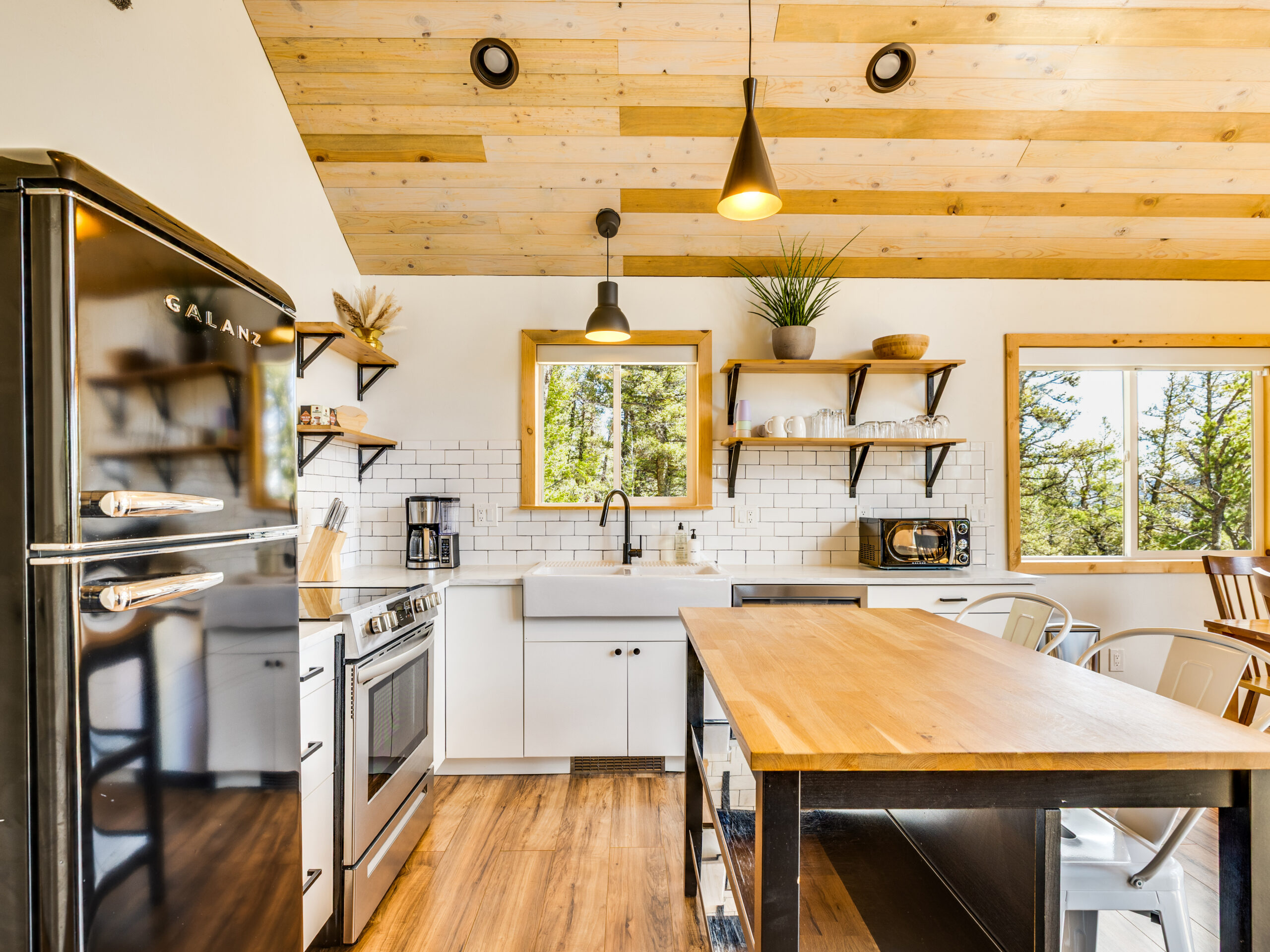 Modern kitchen with stainless appliances, cherry cabinets, and hardface counters.